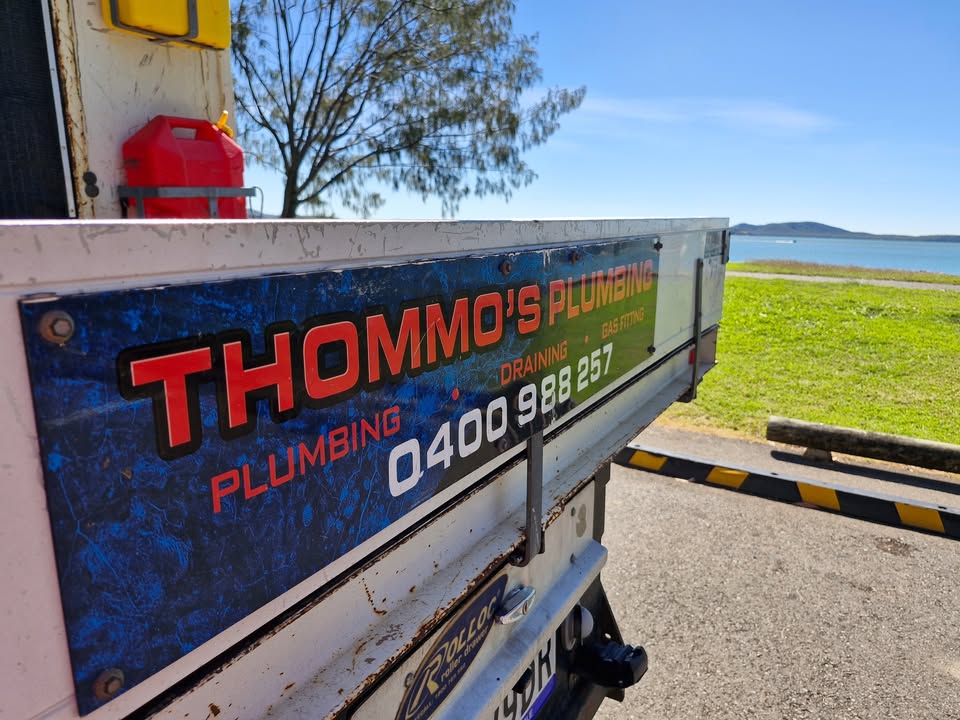 The Thommo's Plumbing sign on the back of the ute: plumbing, draining, gas fitting, 0400 988 257