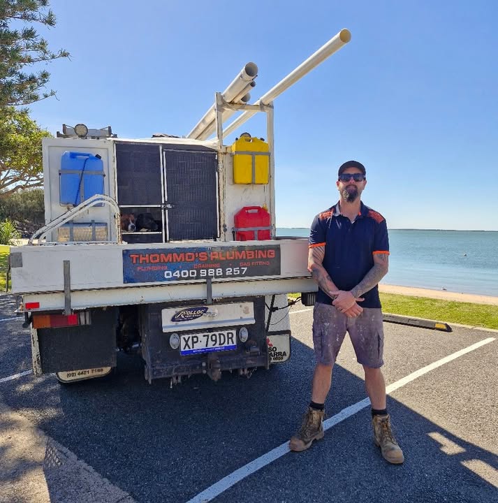 Brad from Thommo's Plumbing standing beside his plumbing ute on the Gladstone foreshore